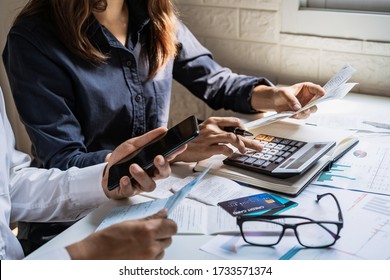 Stressed Young Couple Checking Bills, Taxes, Bank Account Balance And Calculating Expenses In The Living Room At Home