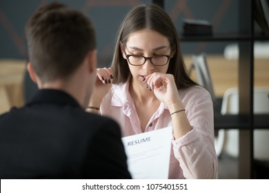 Stressed young female applicant feeling nervous at job interview while hr reading resume, unprepared candidate worried biting nails afraid of bad result at hiring negotiations, fear of fail concept - Powered by Shutterstock