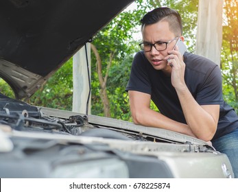 Stressed Young Man Having Trouble With His Broken Car Call Phone