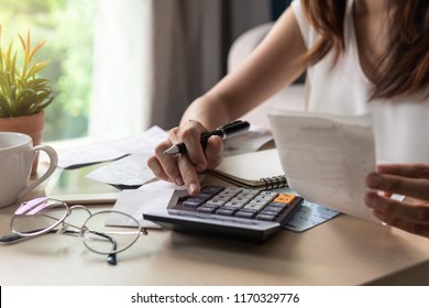 Stressed Young Woman Calculating Monthly Home Expenses, Tax, Bank Account Balance And Credit Card Bills Payment, Income Is Not Enough For Expenses.