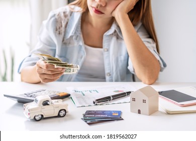 Stressed young woman calculating monthly home expenses, taxes, bank account balance and credit card bills payment, Income is not enough for expenses