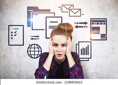 Stressed Young Woman In Checkered Shirt Sitting Near Concrete Wall With Electronic Documents And Internet Icons. Concept Of Information Overload. Toned Image