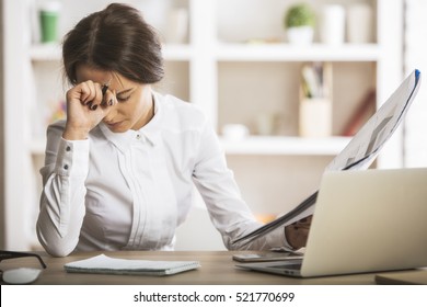 Stressed Young Woman Doing Paperwork At Modern Workplace. Stress Concept