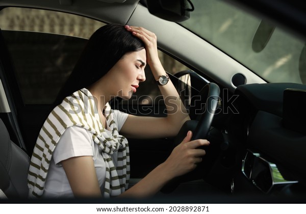 Stressed young\
woman driver\'s seat of modern\
car
