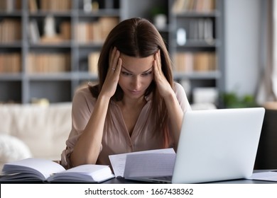Stressed young woman holding head in hands, feeling desperate about financial problems, dismissive notice, failed test. Depressed businesswoman shocked by bank loan rejection, domestic bills.