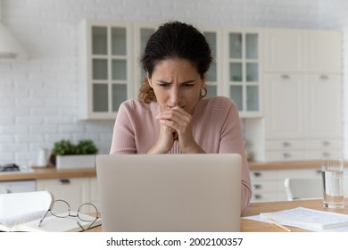 Stressed young woman looking at laptop screen, worrying getting email with bad news, bank mortgage loan rejection. Unhappy businesswoman stack with difficult task, feeling nervous of made mistake.