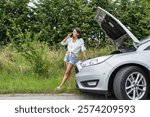 Stressed young woman stand near her broken down car having trouble during summer juorney. Look for help