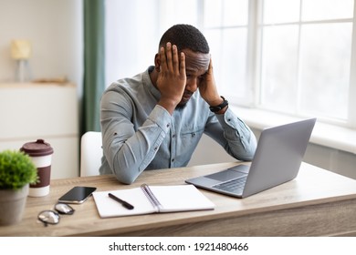 Stressful Job. Stressed African Businessman At Laptop Touching Head Having Problem At Workplace Sitting In Modern Office. Crisis And Entrepreneurship Business Issues, Headache Concept - Shutterstock ID 1921480466