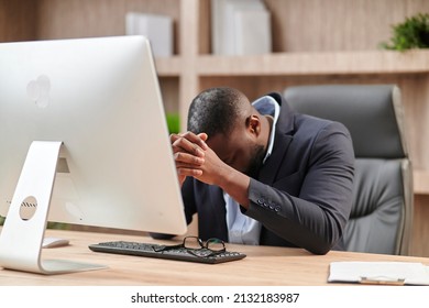 Stressful Job. Stressed African Businessman At Worckplace Touching Head Having Problem At Workplace Sitting In Modern Office. Crisis And Entrepreneurship Business Issues, Headache Concept