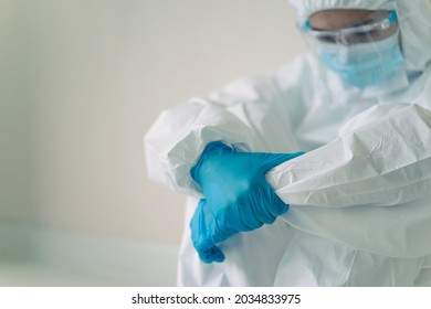 Stressful - Worried Asian Medication Staff Sitting On A Chair Against The Wall, Healthcare Worker Hard Working In Hospital. Overworked Health Care Worker - Nurse Feels Tired.