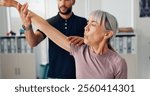 Stretch arm, physical therapy and senior woman or patient at consultation for problem, inflammation or arthritis. Person, chiropractor and exercise for pain, rehabilitation and recovery of muscle