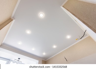 Stretch ceiling in the kitchen with installed and included spotlights