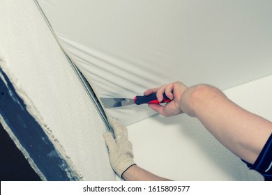 Stretch Ceiling. Workers Stretch The Suspended Ceiling In The Room. Ceiling Installation.