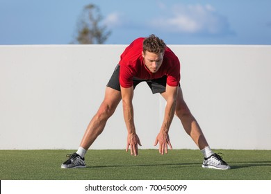 Stretch Fitness Man Toe Touch Stretching Exercise. Standing Forward Bend Stretches Of Legs And Lower Back With Yoga Training For Runners, Flexibility By Touching Feet Exercises In Park.