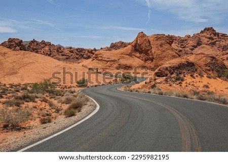 A stretch of road winding through Nevada's dramatic desert landscape