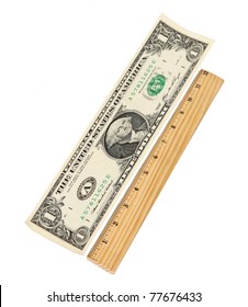 Stretch those Dollars! Dollar bill stretched out and measured against a wooden ruler. Concept of stretching your dollar to make it go further.