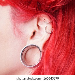 Stretched Ear Lobe Piercing With Flesh Tunnel