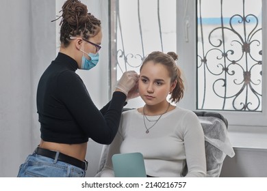 Stretched Lobe Piercing, Grunge Concept. Pierced Woman Ear With Black Plug Tunnel. Industrial And Rook.