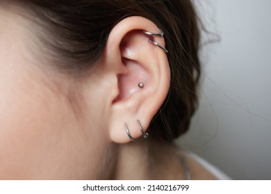 Stretched Lobe Piercing, Grunge Concept. Pierced Woman Ear With Black Plug Tunnel. Industrial And Rook.