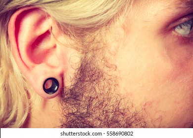 Stretched Lobe Piercing, Grunge Concept. Pierced Man Ear With Black Plug Tunnel