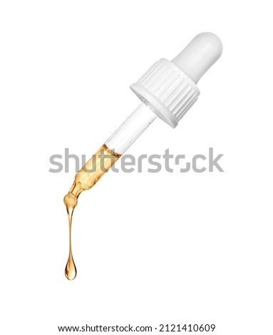 Stretched oily drop falls from a cosmetic pipette close-up on a white background