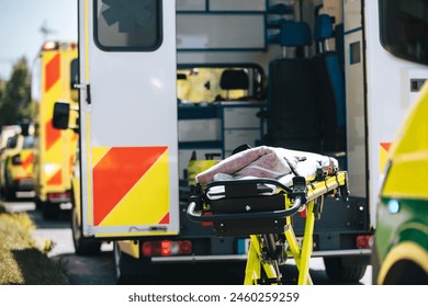 Stretcher prepared behind open ambulance. Teams of emergency medical service on city street.Themes rescue, urgency and health care.
 - Powered by Shutterstock