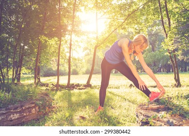 Stretching After Exercise/jogging In The Park.