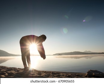 Stretching After Jogging. Middle Age Sports Man Do Stretching Pose And Deep Breath. Outdoor Training At Offshore, People And Lifestyle Concept.