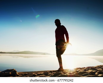 Stretching After Jogging. Middle Age Sports Man Do Stretching Pose And Deep Breath. Outdoor Training At Offshore, People And Lifestyle Concept.