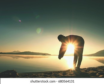 Stretching After Jogging. Middle Age Sports Man Do Stretching Pose And Deep Breath. Outdoor Training At Offshore, People And Lifestyle Concept.