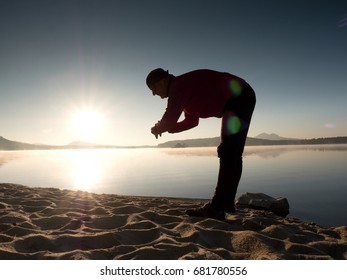 Stretching After Jogging. Middle Age Sports Man Do Stretching Pose And Deep Breath. Outdoor Training At Offshore, People And Lifestyle Concept.