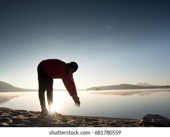 Stretching After Jogging. Middle Age Sports Man Do Stretching Pose And Deep Breath. Outdoor Training At Offshore, People And Lifestyle Concept.