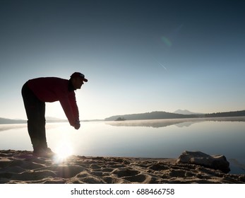 Stretching After Jogging. Middle Age Sports Man Do Stretching Pose And Deep Breath. Outdoor Training At Offshore, People And Lifestyle Concept.