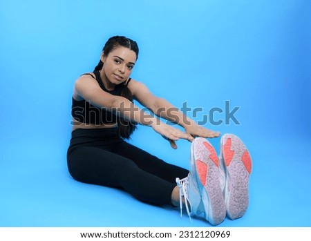 Stretching Exercise by Young Indian Fit Gym Girl - Woman Touching Toes with Hands Concept 
