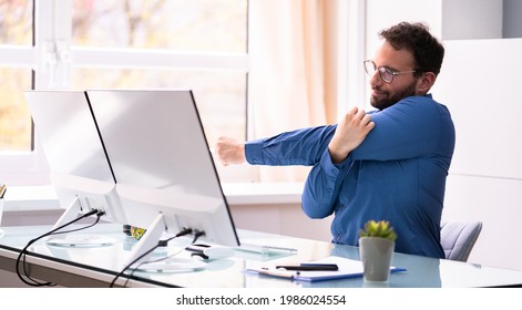 Stretching Exercise At Office Desk In Chair