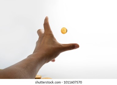 Stretching hands to grab gold coin first person point of view 