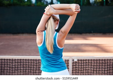 Stretching sports woman or tennis player warming up. on court. back view - Powered by Shutterstock