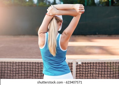 Stretching sports woman or tennis player warming up. on court. back view - Powered by Shutterstock