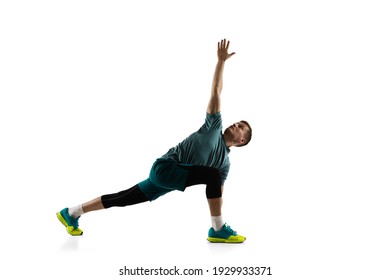 Stretching. Young caucasian male model in action, motion isolated on white background with copyspace. Concept of sport, movement, energy and dynamic, healthy lifestyle. Training, practicing. Authentic - Powered by Shutterstock