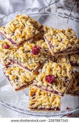 Similar – square pieces of cake crumble with cherry