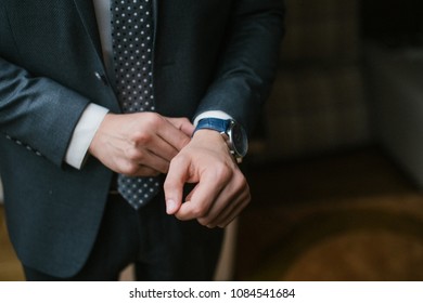 strict arm suit with wedding rings