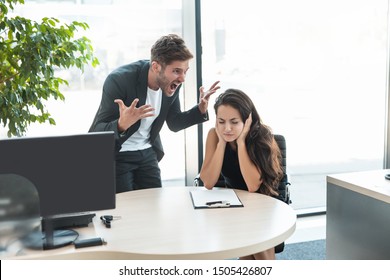 Strict Boss Man Swearing At Depressed Employee Woman For Bad Work At The Workplace Looking Angry