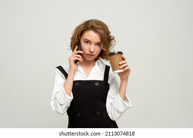 Strict Business Woman Talk On Phone And Drink Coffee On Grey Background