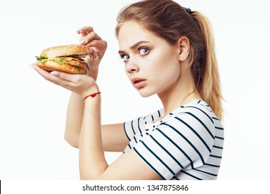 Strict Diet Woman In A Striped T-shirt Fast Food Hamburger