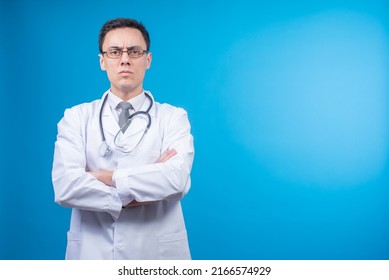 Strict Doctor In Glasses Against Blue Backdrop