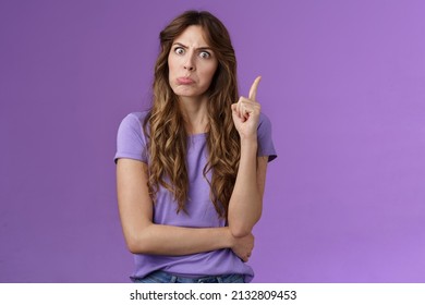 Strict Funny Curly-haired Girl Pulling Disappointed Angry Face Popping Eyes Stare Camera Shaking Index Finger Disapproval Scold Bad Behaviour Stand Serious Bossy Purple Background