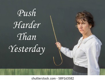 Strict Looking Edwardian Teacher With The Inspirational Message Of Push Harder Than Yesterday In A School Room Setting