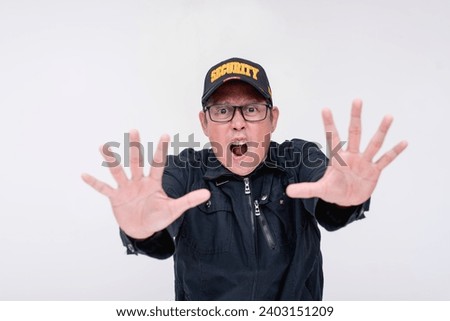 A strict male security guard shouting ordering you to stop. Gesturing with palm to halt, commanding with urgency and heightened emotions. Isolated on a white background.