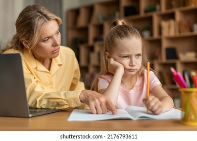 Strict Mother Scolding Upset Daughter For Bad Marks Or School Exam Results, Mum Lecturing Unmotivated Girl, Pointing To Notebook. Generations, Parent And Child Conflict