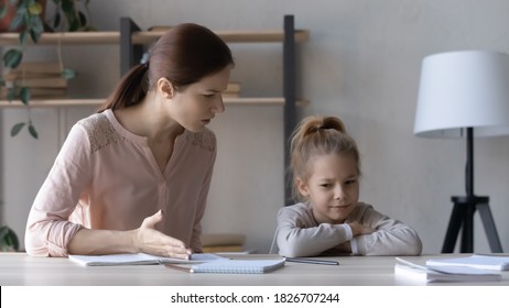 Strict Mother Scolding Upset Little Daughter For Bad Marks, Sitting At Table At Home, Angry Serious Mum Lecturing Lazy Unmotivated Schoolgirl, Children Education Problem, Parent And Child Conflict